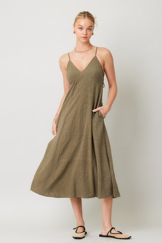 olive linen stripe midi dress worn by woman on a white background