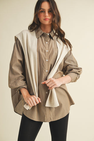 Woman wearing a beige and brown striped shirt with a beige scarf on a beige background