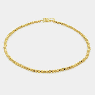 A gold-plated stainless steel choker necklace with a beaded design, featuring a lobster clasp closure.