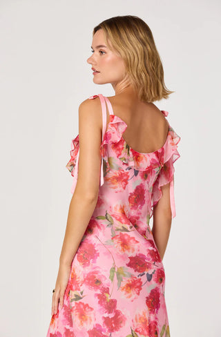 Woman wearing a pink floral dress on a white background