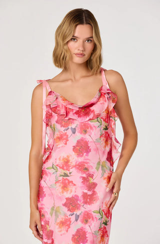 Woman wearing a pink floral dress on a white background
