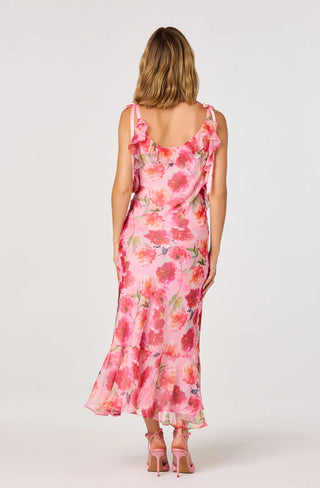 Woman wearing a pink floral dress on a white background