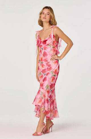 Woman wearing a pink floral dress on a white background