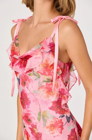 Pink floral dress with ruffled straps on a white background
