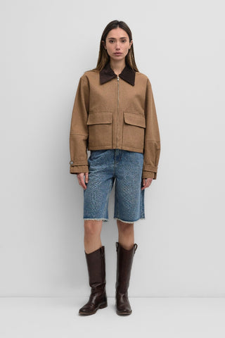 The Barn Jacket is a work-style zip-up jacket with a contrast corduroy collar, front flap pockets, and an adjustable button-back hem and sleeve cuffs for added utility.
