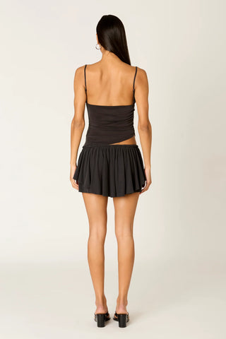 Woman wearing a black dress with a plain background