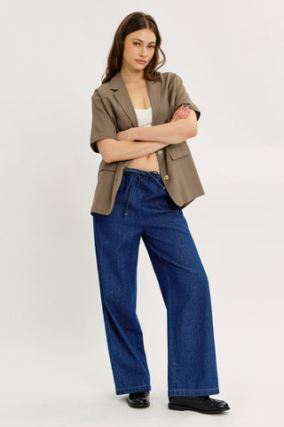 Blue denim drawstring pants shown in a full outfit 
