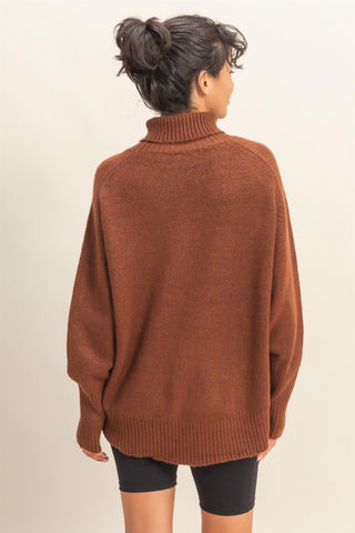Person wearing a brown sweater on a beige background