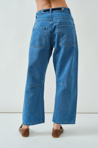 Blue jeans worn by a person on a white background