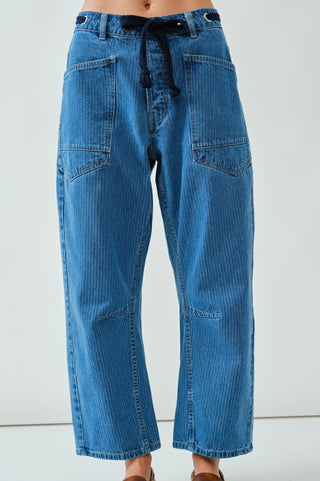 Blue jeans worn by a person on a white background