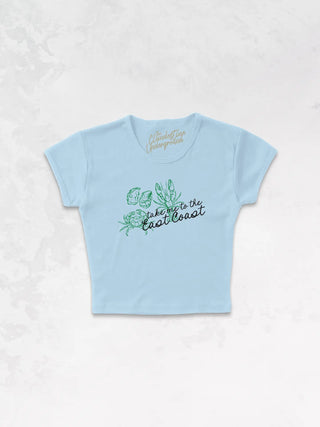 Blue baby tee with graphic saying "Take me to the East Coast" with lobster, crab and oyster shell graphic.