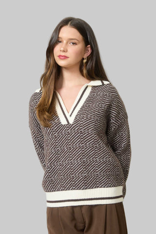 Woman wearing a patterned sweater in an office setting