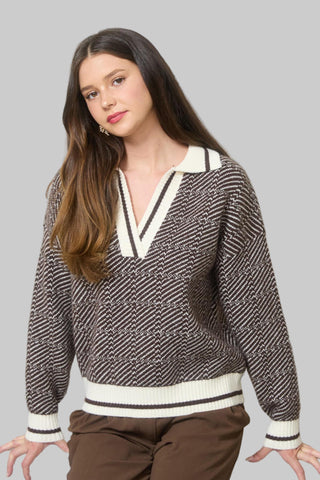 Woman wearing a patterned sweater in an office setting