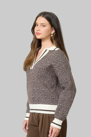 Woman wearing a patterned sweater in an office setting