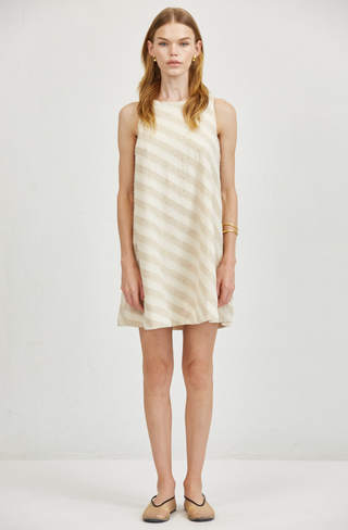Woman wearing a sleeveless dress with vertical stripes on a plain background