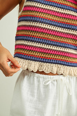 Colorful striped sleeveless top with lace trim worn by a person, on a plain background.