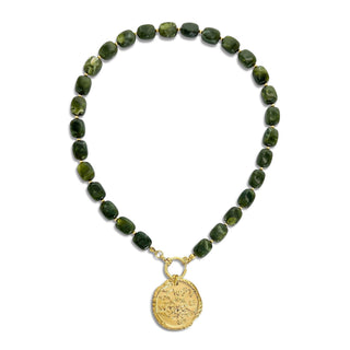 A beaded necklace featuring dark green polished stone beads and a gold-toned circular medallion pendant, displayed on a clean white background.