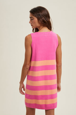 Back view of sleeveless mini sweater dress with bold pink and orange horizontal stripes.  