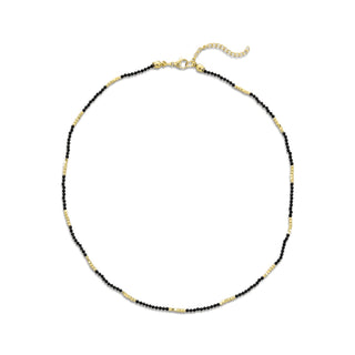 Necklace with black and gold beads on a white background