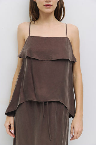 Front view of brown spaghetti strap tank with soft ruffle overlay, styled with matching drawstring skirt