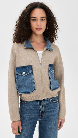 Detail view of the BLANKNYC Glow Up Sweater from the front, showcasing its soft knit texture, ribbed detailing, and denim pockets and collar. Designed for a cozy yet elevated look.