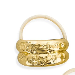 Three gold rings with unique designs on a white background
