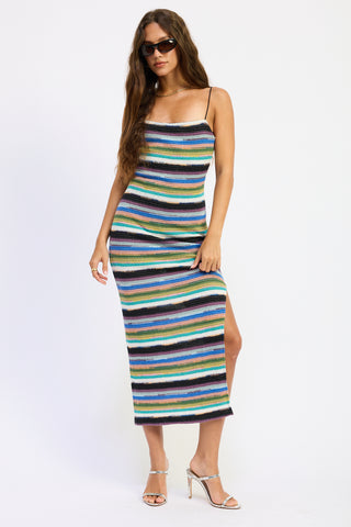 Woman wearing a colorful striped dress on a white background