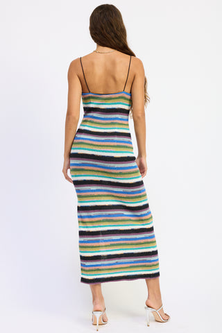 Woman wearing a colorful striped dress on a white background