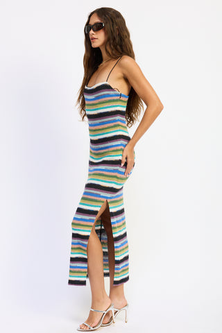 Woman wearing a colorful striped dress on a white background