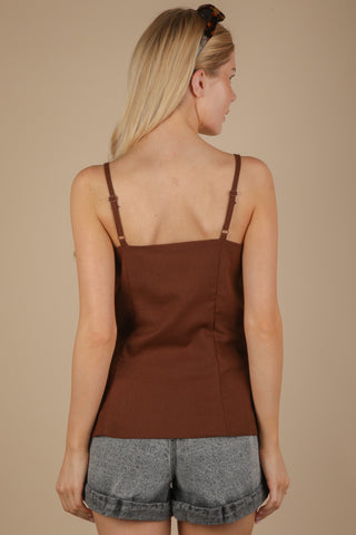 woman wearing brown button down top. back view showing adjustable straps.