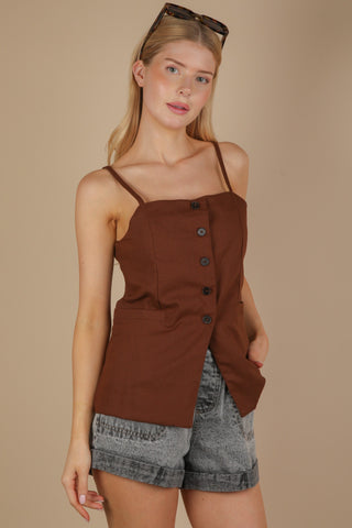 woman wearing brown button down top showing adjustable thin straps & black buttons.