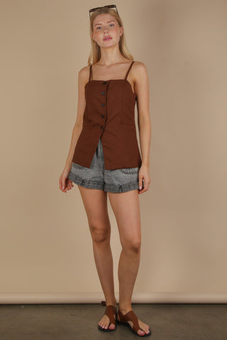 zoomed out view of brown button down top with shorts.