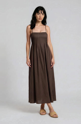 Woman wearing a brown dress on a white background