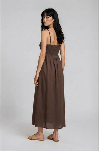 Woman wearing a brown dress on a white background