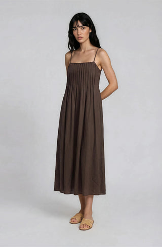 Woman wearing a brown dress on a white background