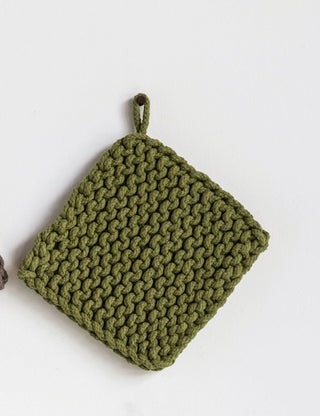 Four knitted pot holders in brown, green, black, and gray on a white background