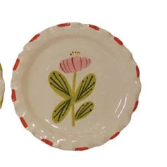 Set of five ceramic plates with floral designs on a white background