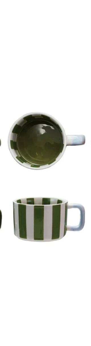 Hand-painted stoneware mug featuring vivid green stripes and a soft blue handle. A fresh, artisanal touch to your morning coffee routine — sturdy, microwave- and dishwasher-safe.