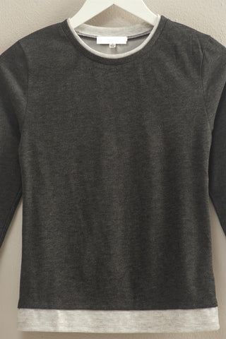 Gray sweatshirt with a white label on a beige background