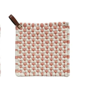 Single red and white cotton crochet pot holder with leather loop, displayed on white background.
