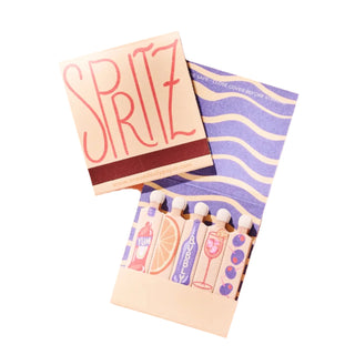 A matchbook with 'SPRITZ' written on the cover, featuring a colorful design. The matchbook is open, displaying the matches inside.