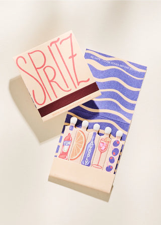 An image of a matchbook with a beige cover featuring the word 'SPRITZ' in red letters, with additional decorative patterns in the background.