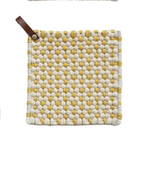 Single yellow and white cotton crochet pot holder with leather loop, displayed on white background.